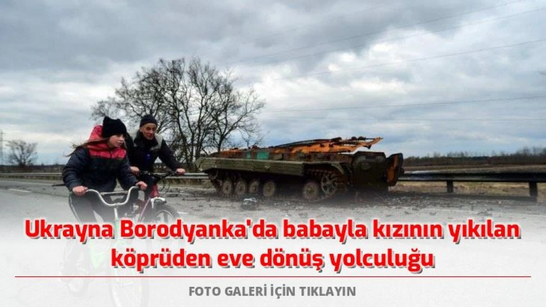 Ukrayna Borodyanka'da babayla kızının yıkılan köprüden eve dönüş yolculuğu